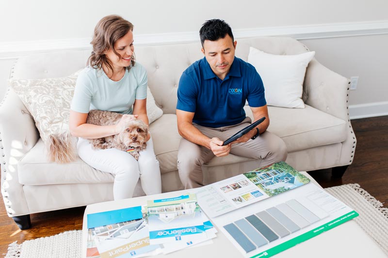 Dixon Painting expert showing paint samples to a woman in Kennesaw, GA