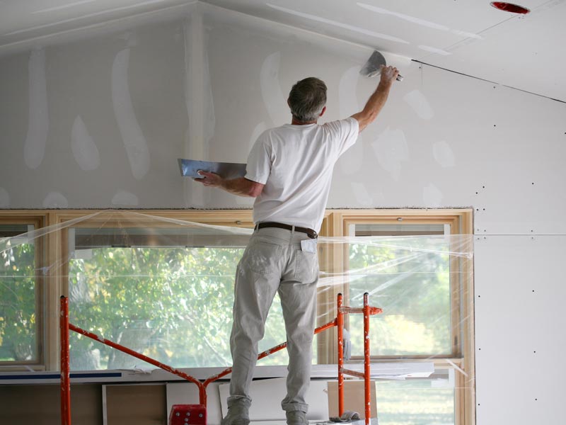A professional is repairing the drywall in Atlanta and Roswell, GA