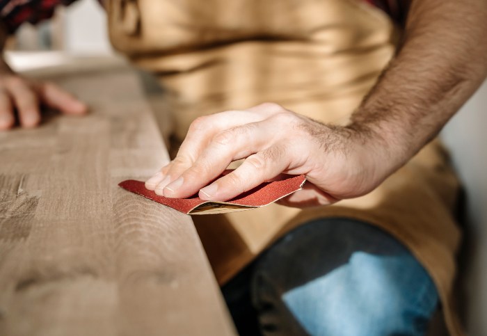 Man sanding the wood for flawless Finish - Dixon Painting