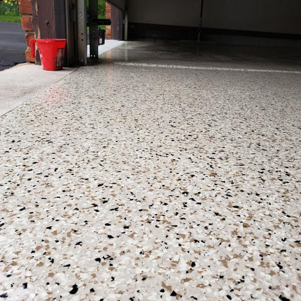 Dixon Painting team applying shiny epoxy on a garage floor in Atlanta, GA